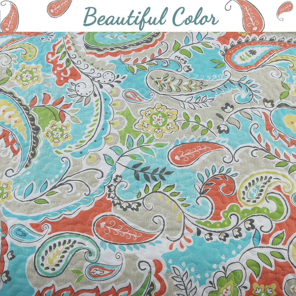 Close-up paisley floral fabric pattern in teal, green, orange, and cream