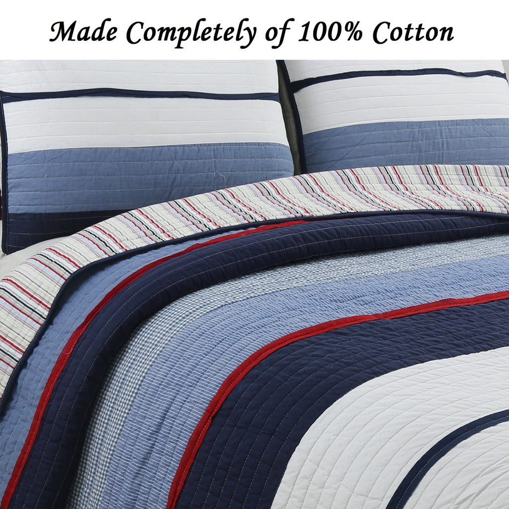 Reversible quilt bedding set with blue striped panels and red trim, navy backing