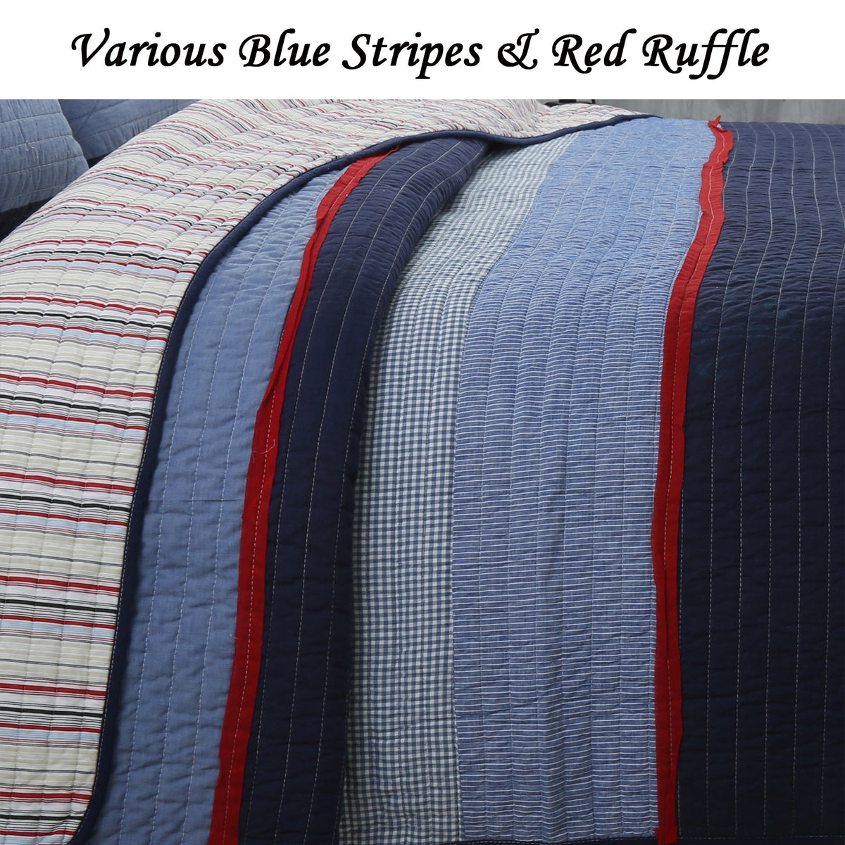 Reversible quilt with layered blue stripe panels, navy edge, and red ruffle trim