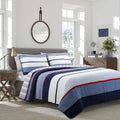 Reversible quilt set with blue and white striped quilt, navy border, and red trim