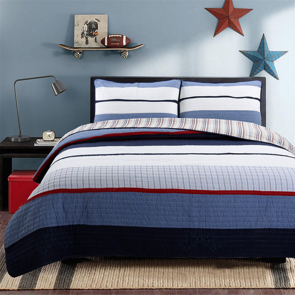 Reversible quilt bedding set with horizontal blue, white, and red stripes over navy base