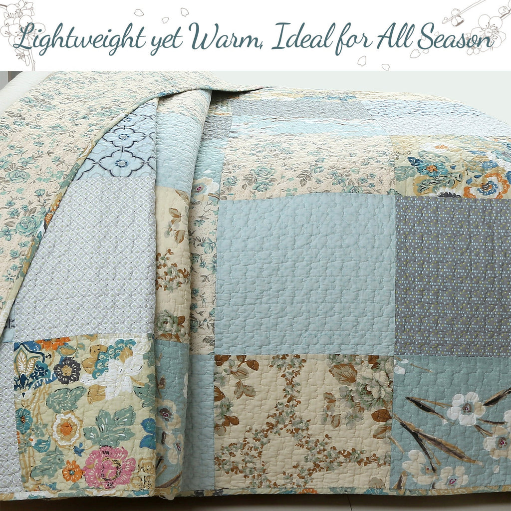 Quilt comforter with patchwork blocks and floral prints in sky blue, cream, and tan