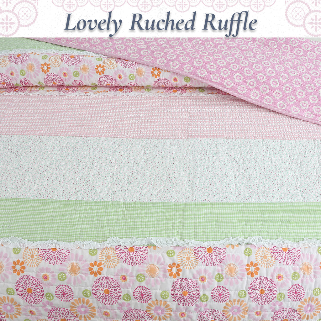 Pastel quilt with pink ruffled trim and floral stripe top edge