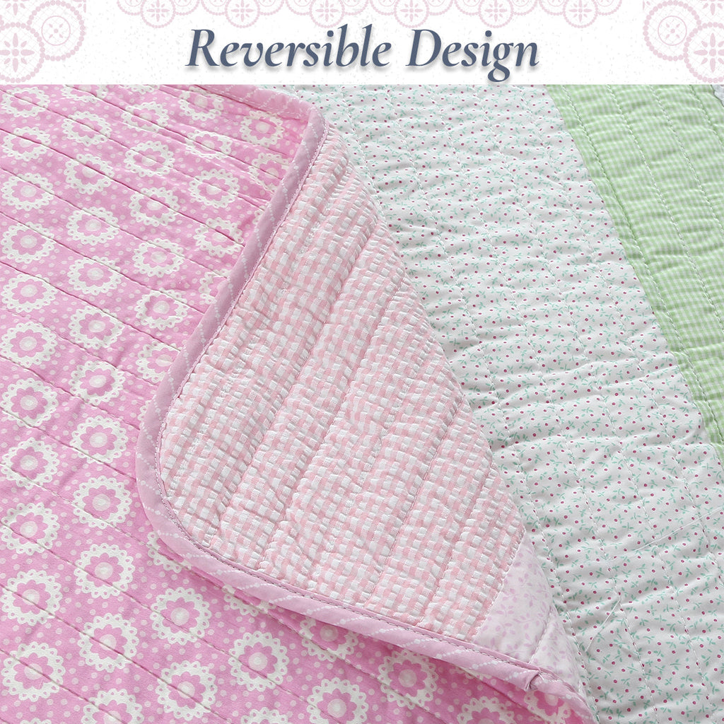 Reversible cotton quilt with pink floral side and green and white dotted side