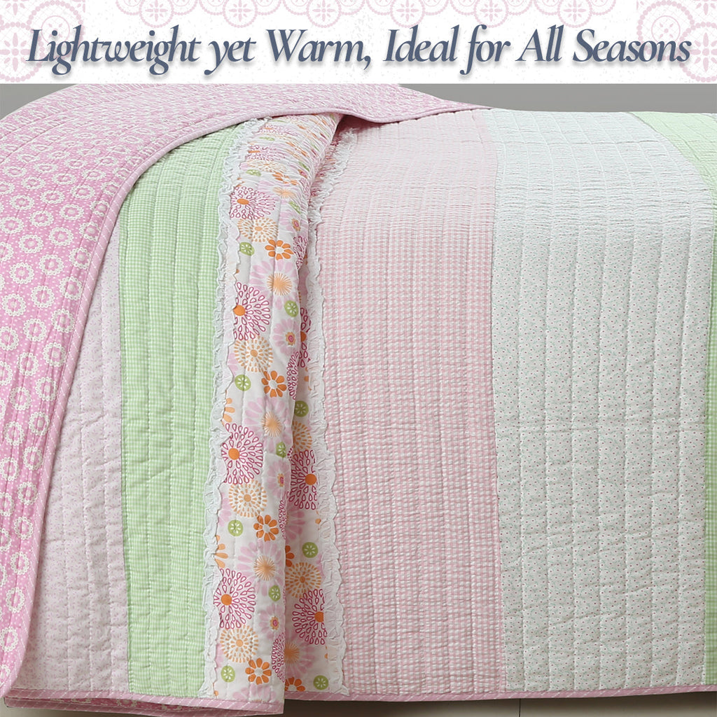 Lightweight cotton quilt showing reversible pastel patchwork panels in pink, green, white