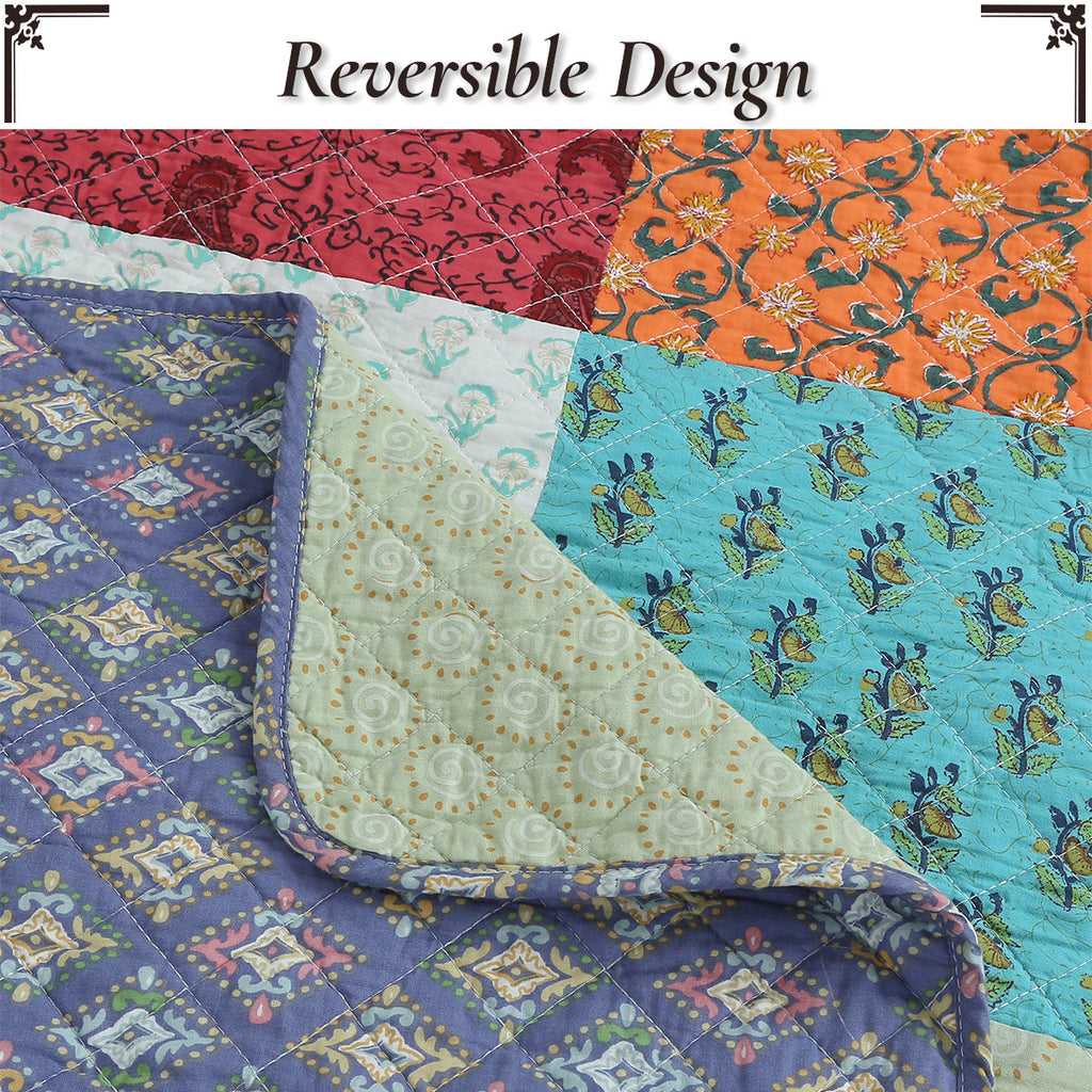 Reversible quilt top with blue and orange floral panels and multicolor patchwork blocks