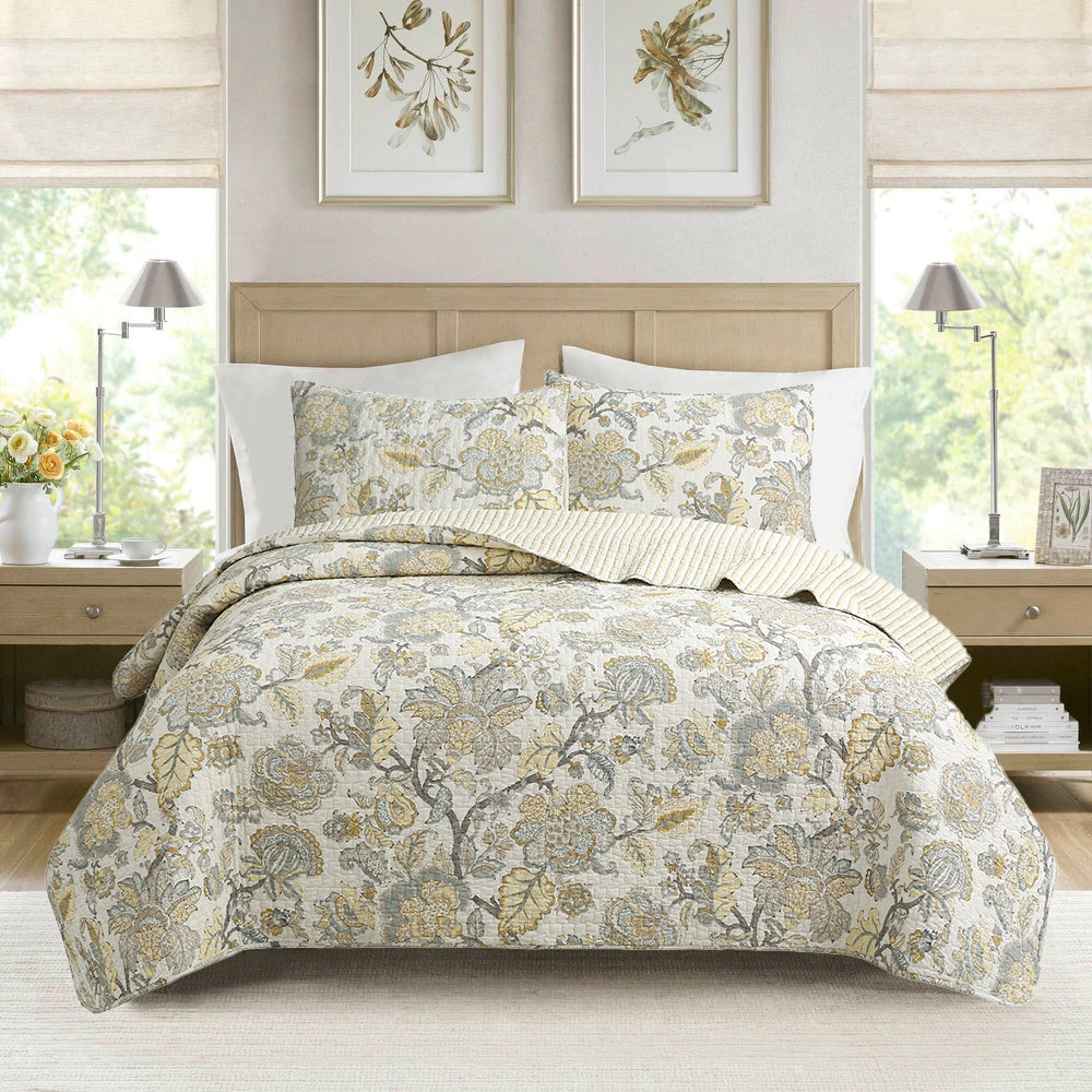 Quilt bedding set with botanical floral print, cream and gold accents, with matching pillows