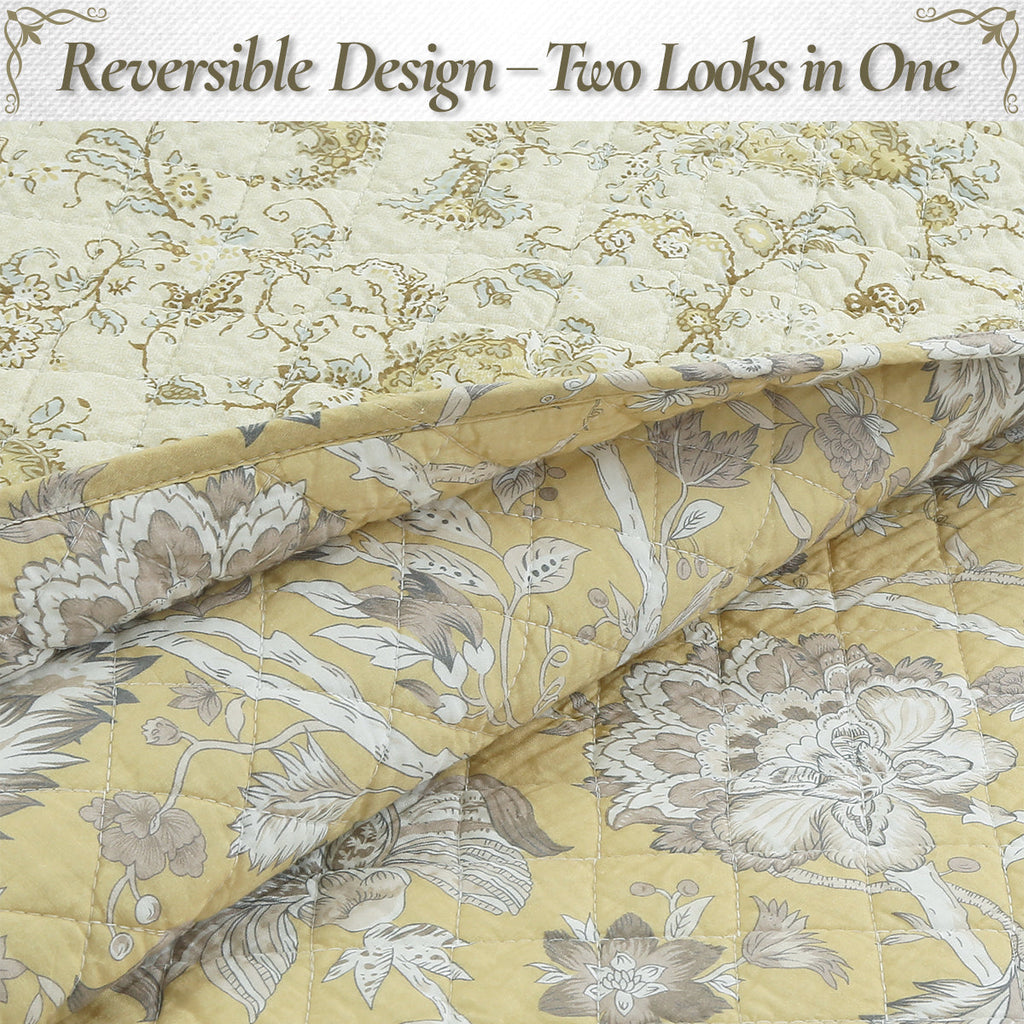 Reversible quilt with light yellow base and gray floral motifs, quilted folds