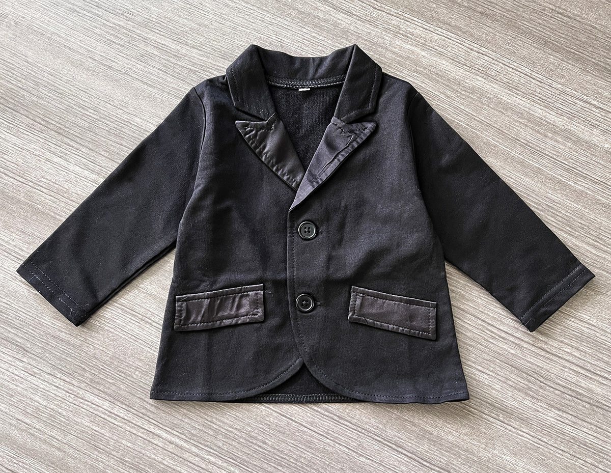 Black baby blazer with notched collar, button front, and chest pocket accents