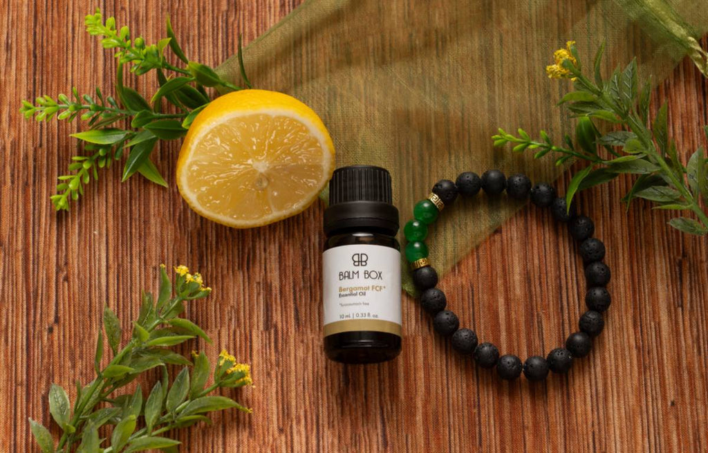 Botanical balm bottle with half orange and beaded bracelet