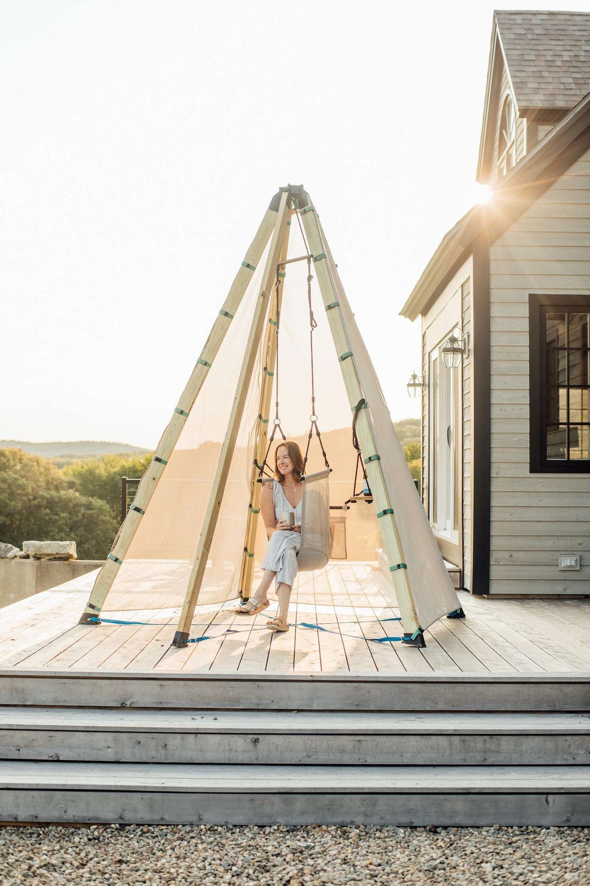 Outdoor wooden teepee with canvas canopy on a front porch