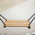 Bijou Rest hanging wooden swing with black rope, straight-on view