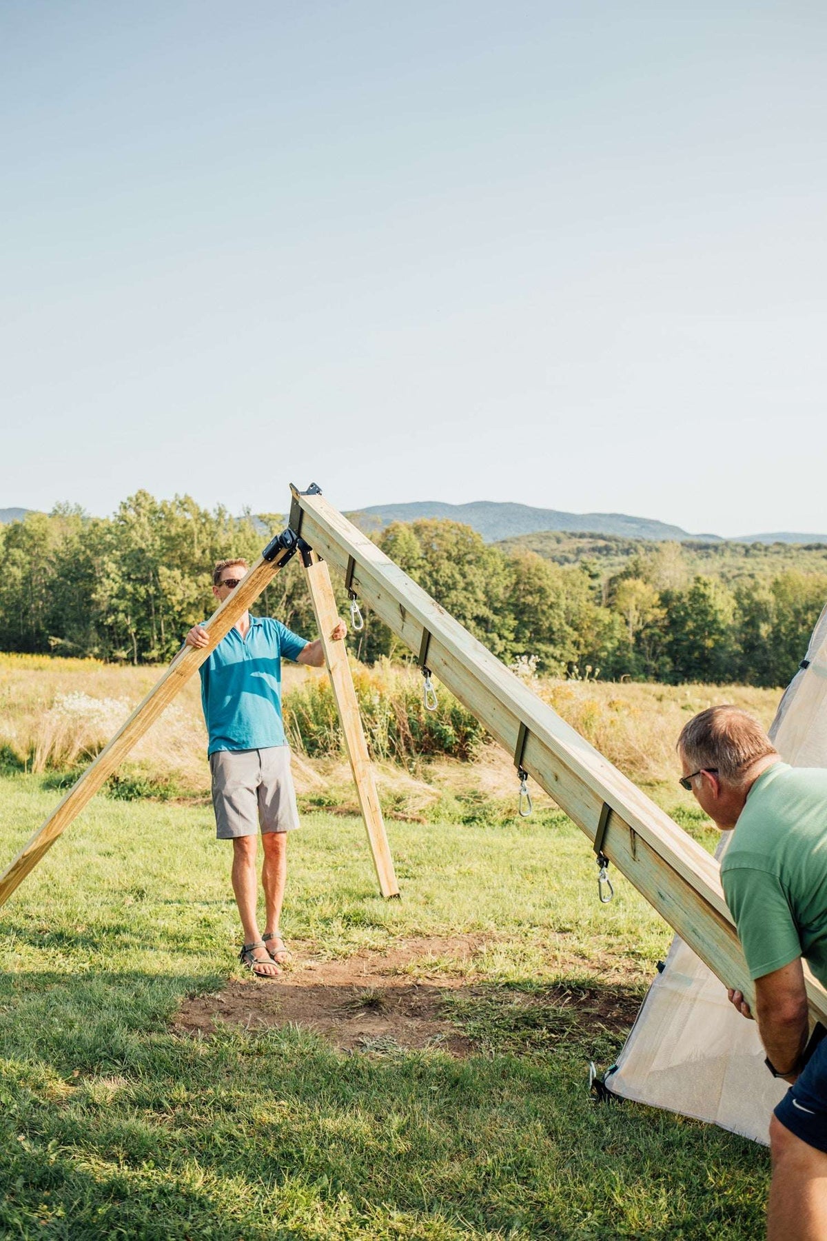 Swing arm adaptor assembly on wooden A-frame with hanging swing ropes
