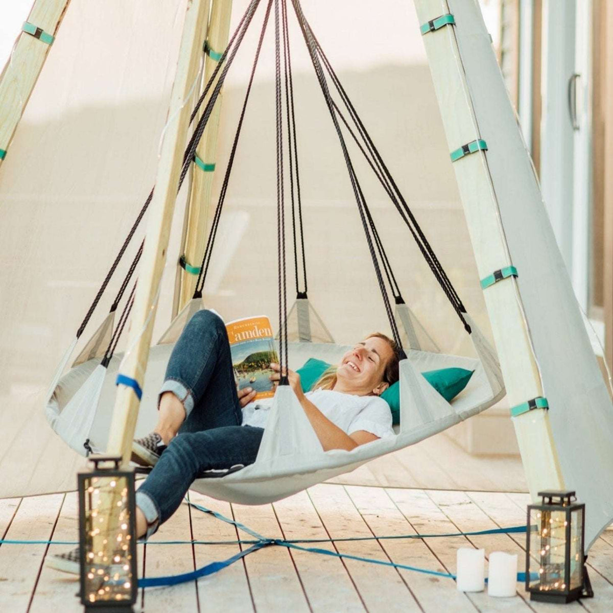 Off-white tipi play tent interior hammock with ropes; person reclining inside