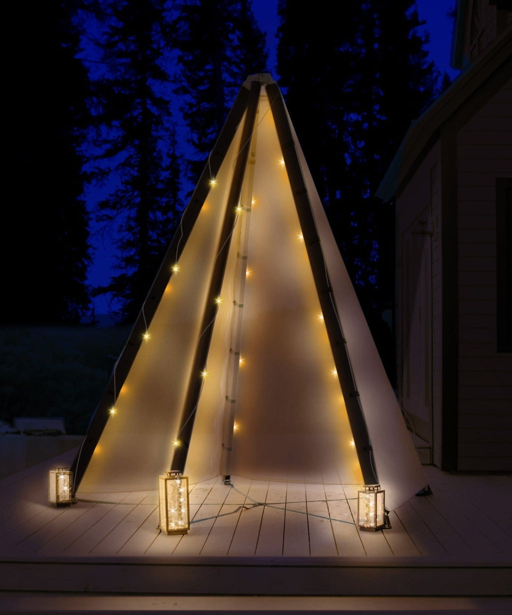 Illuminated wooden teepee shelter with warm string lights
