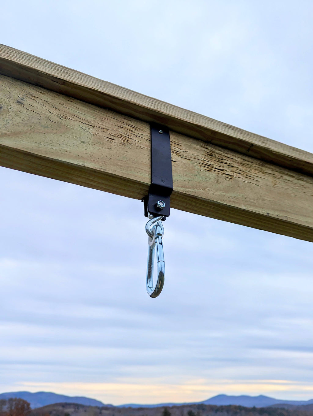 Swing arm adaptor metal hook on a wooden beam for hanging swing ropes