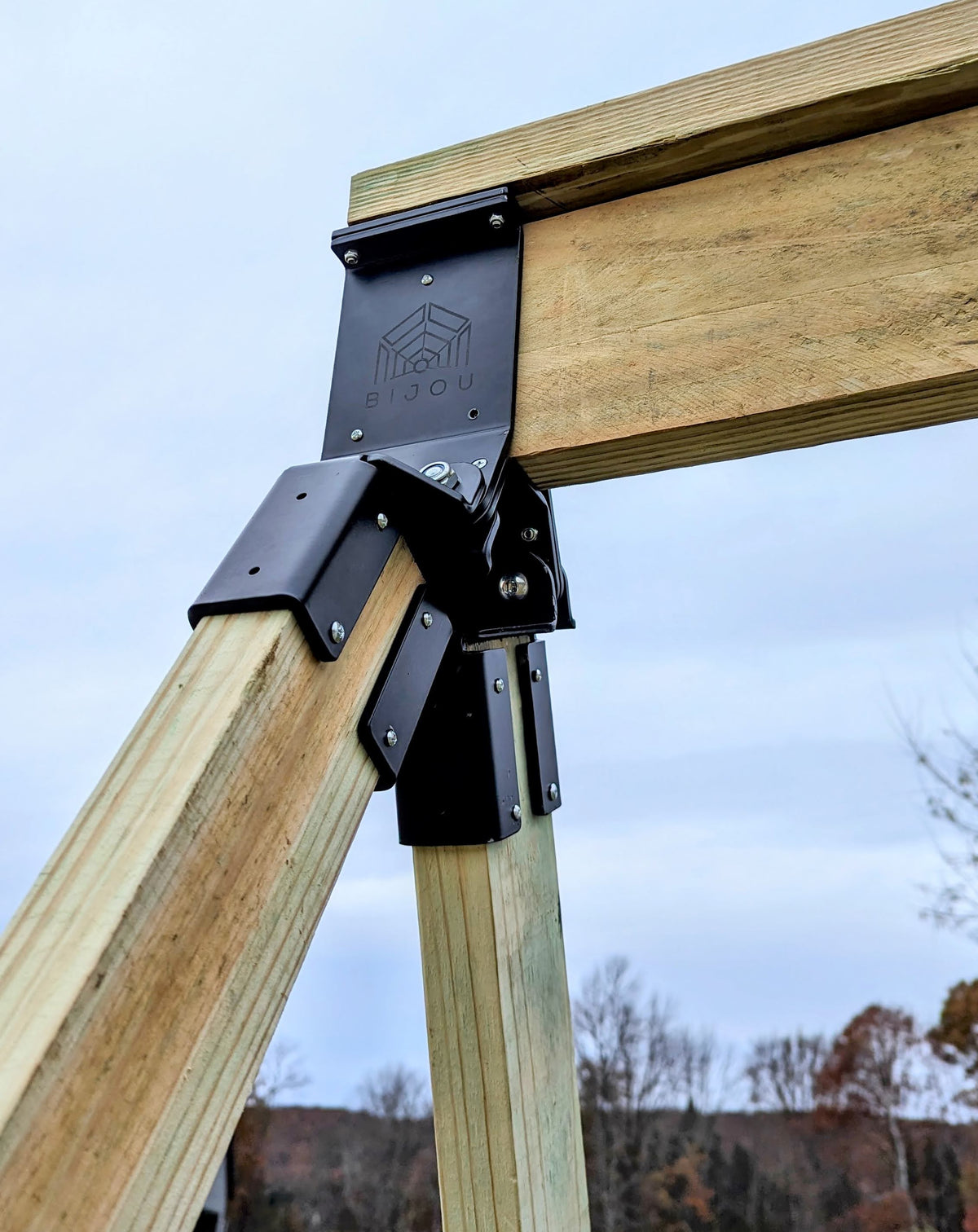 Close-up of swing arm adaptor with metal plates on a wooden beam
