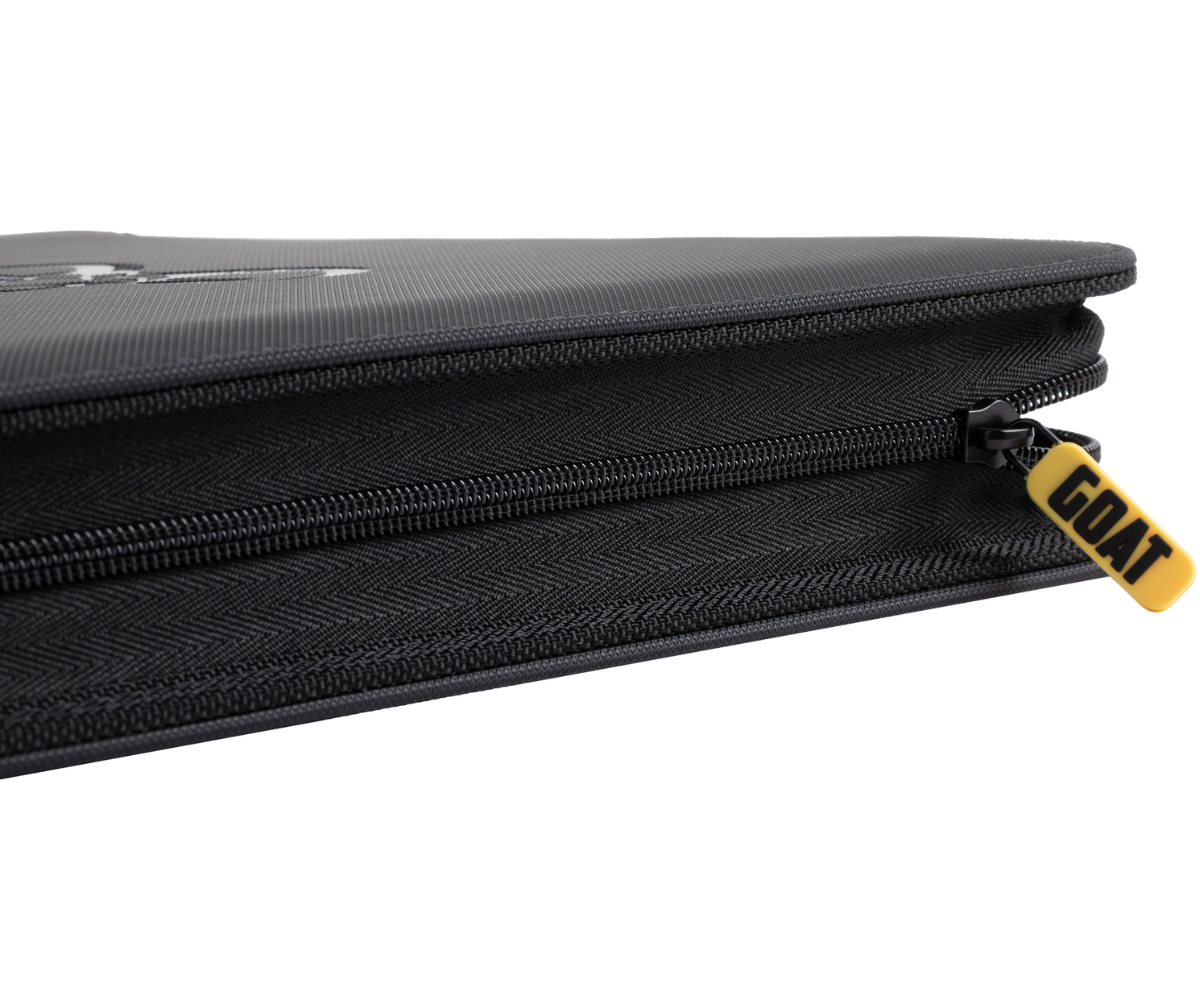 Black card binder spine detail with layered zippers and gold logo tag.