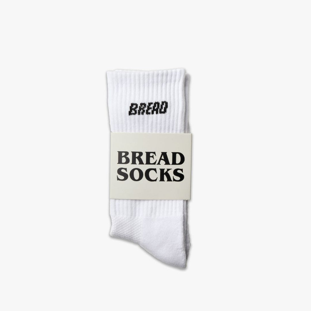 White crew socks with black Bread Socks logo on ribbed knit cuff