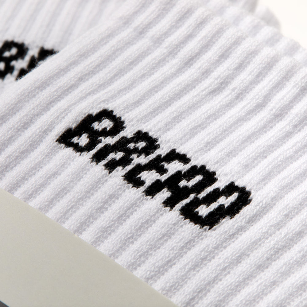White ribbed crew sock with black Bread Socks text logo across leg