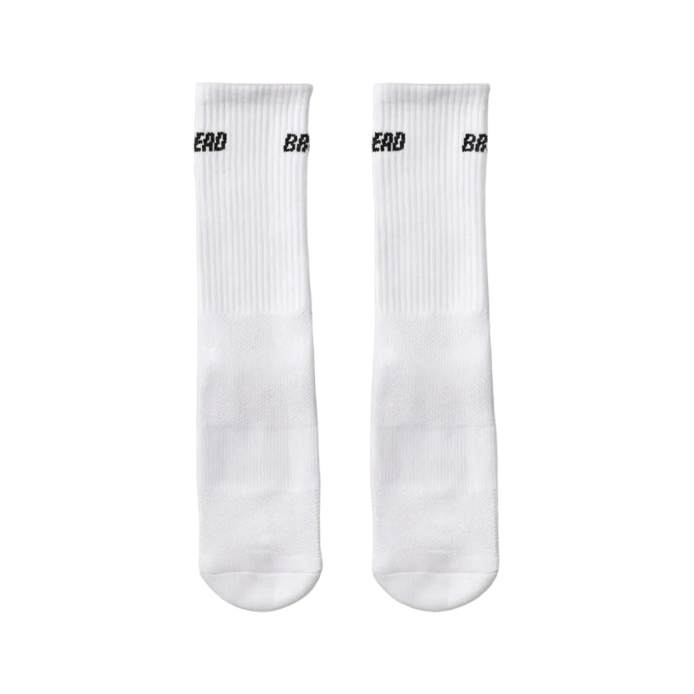 White crew socks with black Bread Socks logo, pair shown flat