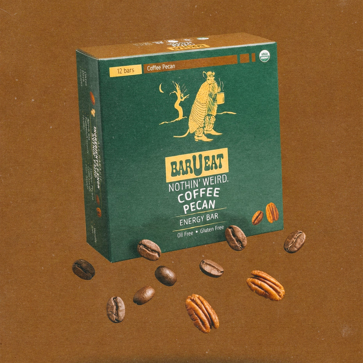 Coffee pecan energy bar box with scattered coffee and pecan kernels