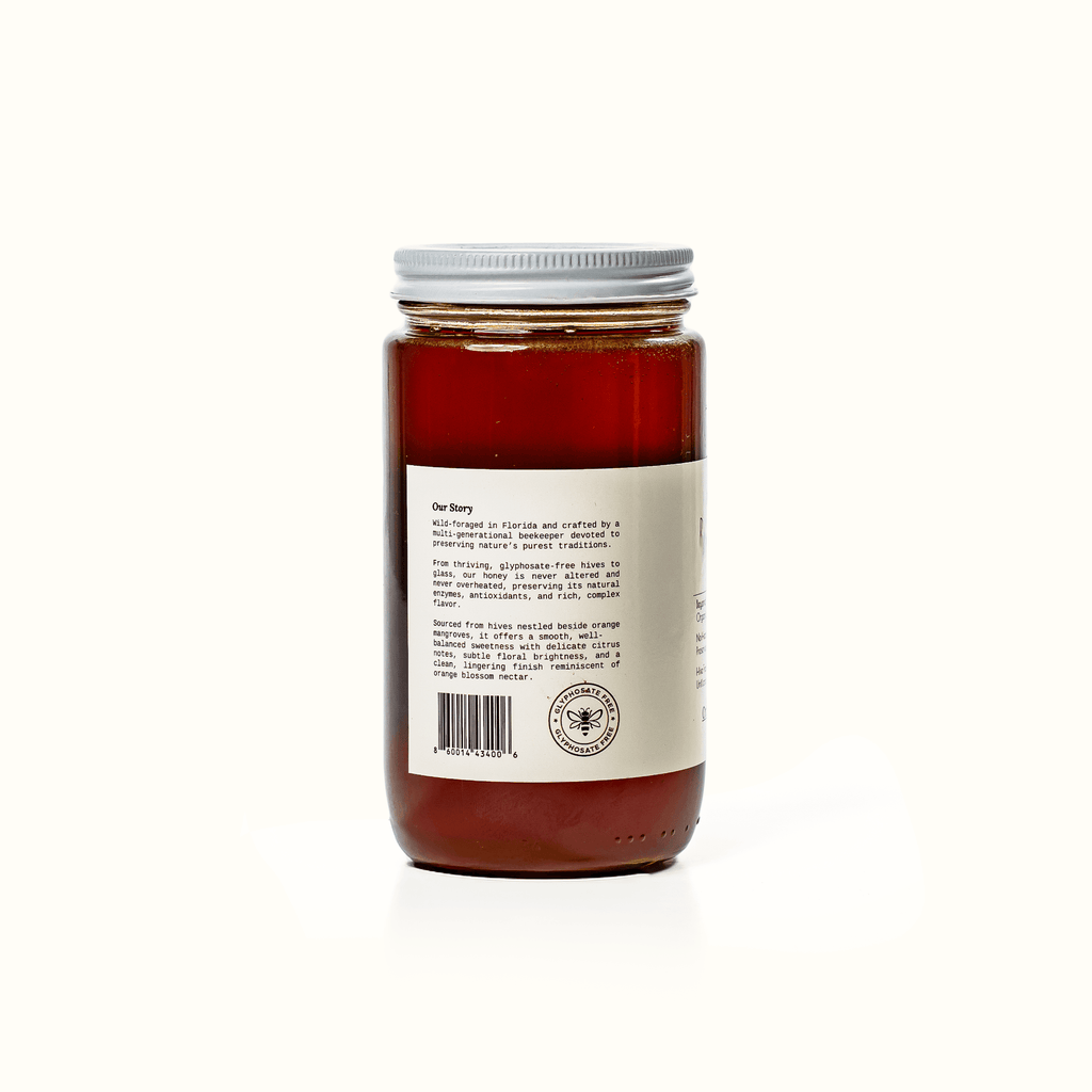 Back label of raw honey jar with barcode and company details, 16 oz