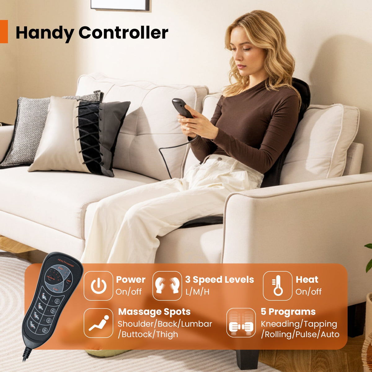 Black back massager seat cushion with handheld remote, woman seated on sofa