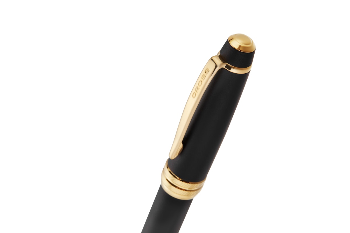 Matte black ballpoint pen with gold clip and cap end, gold PVD accents