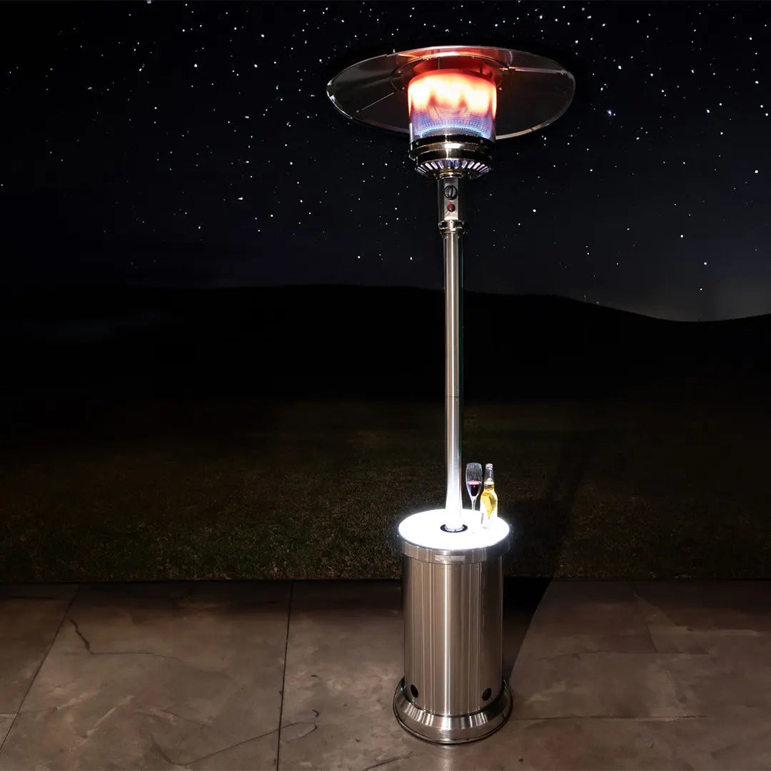 Stainless steel patio heater with glowing heater element at the top