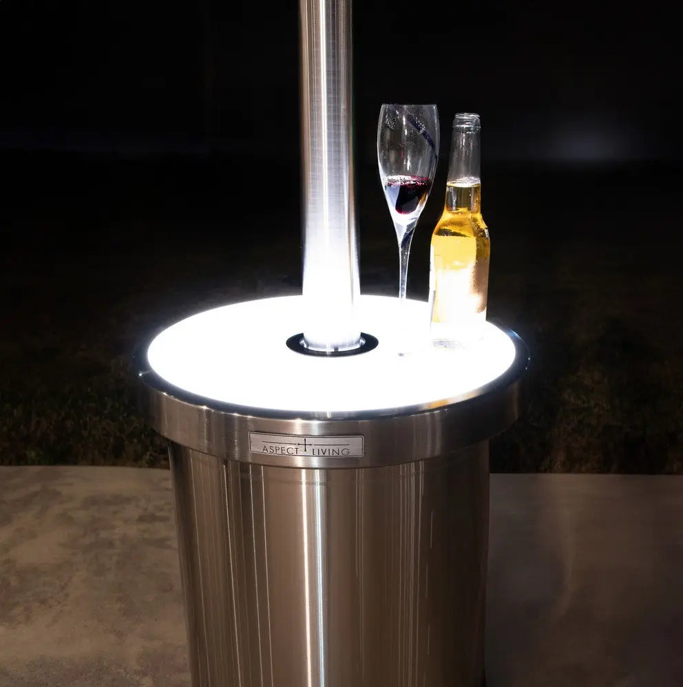 Lit LED tabletop on stainless steel patio heater with glasses and bottle