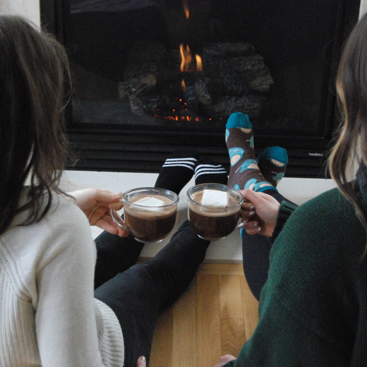 Kids holding mugs of hot cocoa by a fireplace, dairy-free cocoa drinks