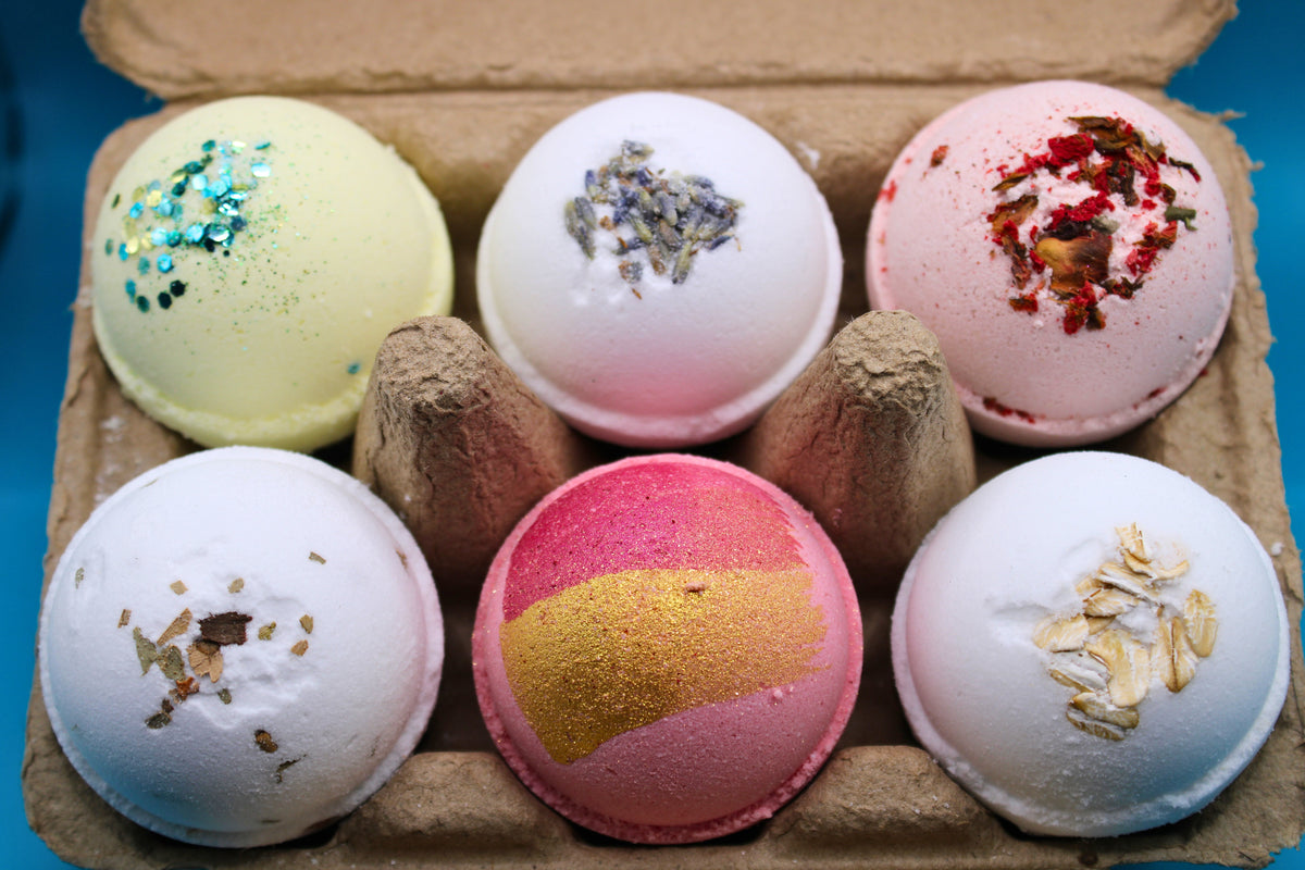 Mini bath bomb bundle in tray showing six colorful bath bombs with glitter center