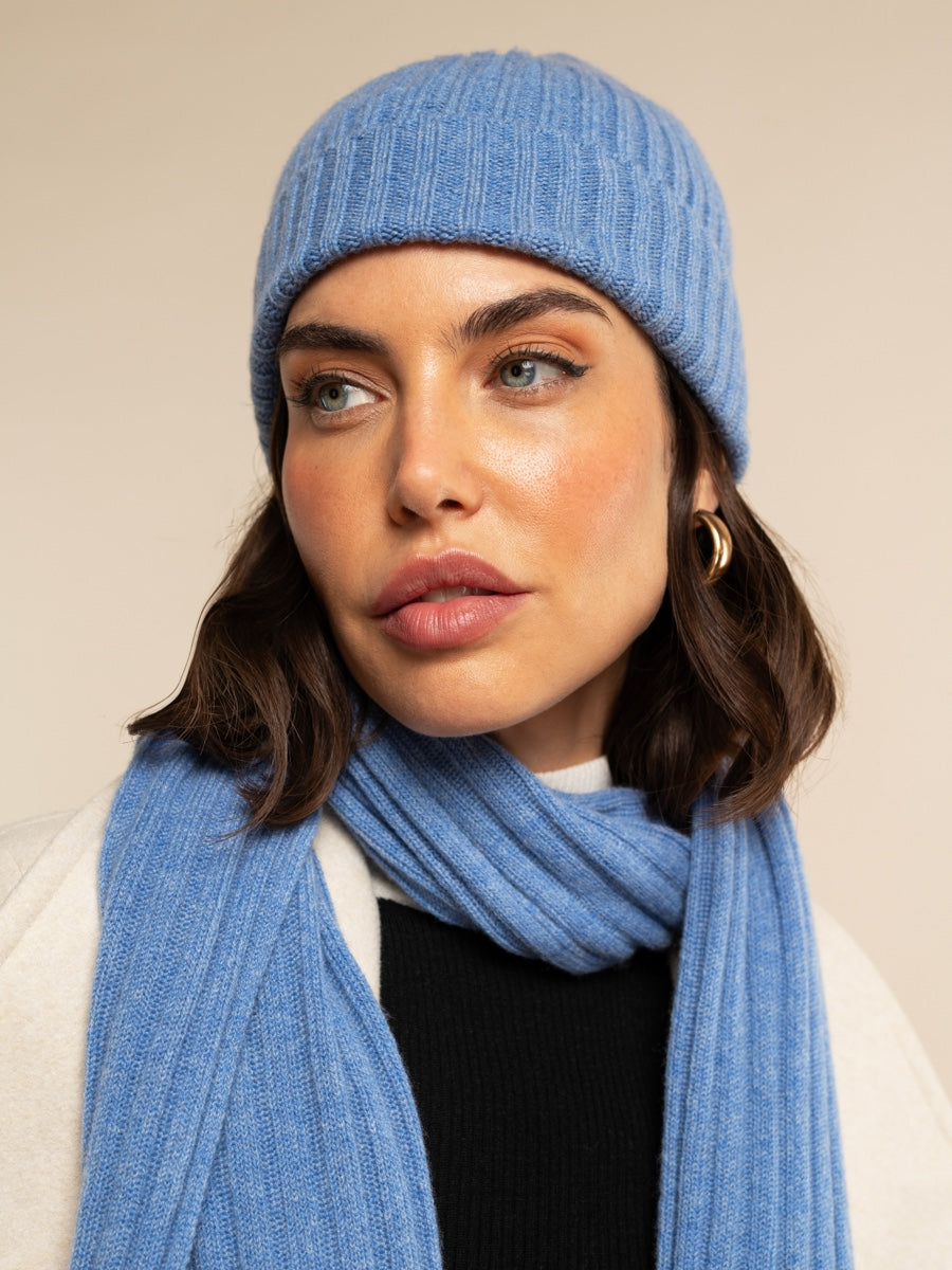 Light blue ribbed knit beanie and matching scarf on model