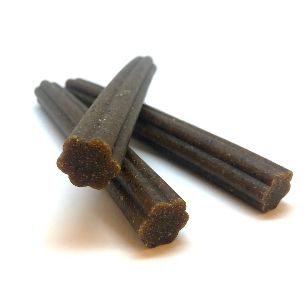 Beef dog chew sticks, three dark brown cylindrical treats