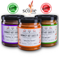 Three hot sauce jars with colorful labels and black lids