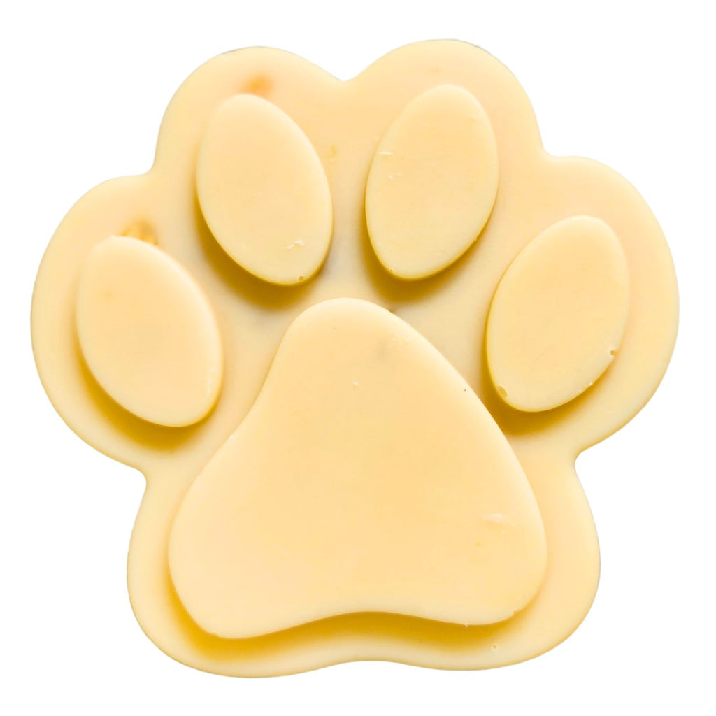 Single paw-shaped goat milk soap bar, light cream color with oval toes