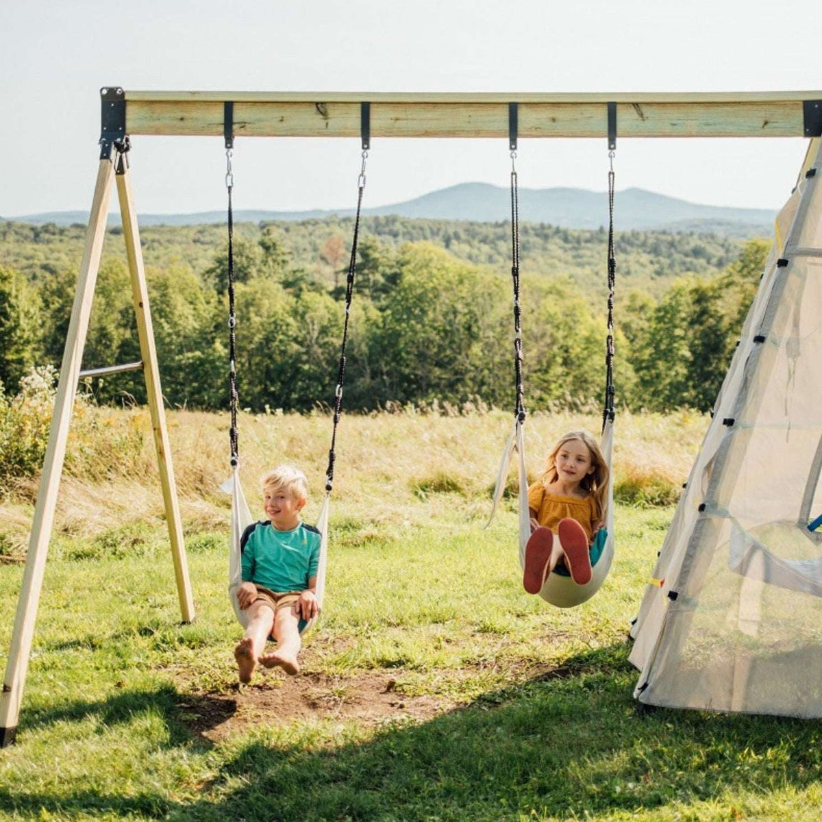 Swing arm adaptor with hanging swing ropes on a wooden playset frame