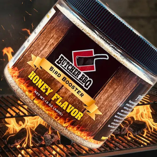 Butcher BBQ Bird Booster Honey Flavor jar, angled label view on grill flames.
