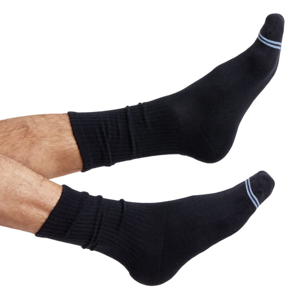 Black crew socks on legs with light blue stripe detail at cuff and toe