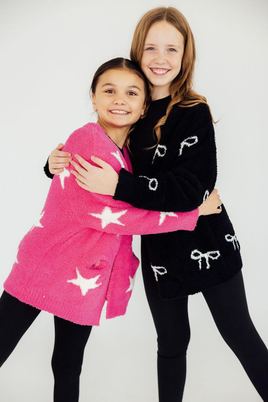Black bow-pattern cardigan with long sleeves, button-front, crew neck