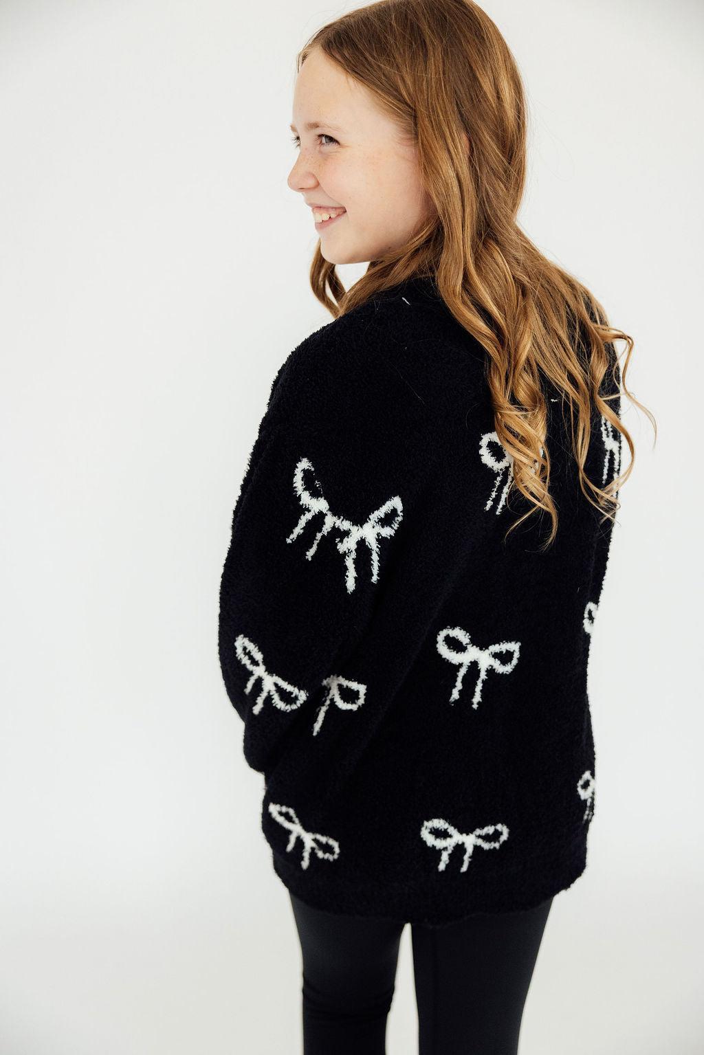 Black bow-pattern cardigan with white bow motifs, long sleeves