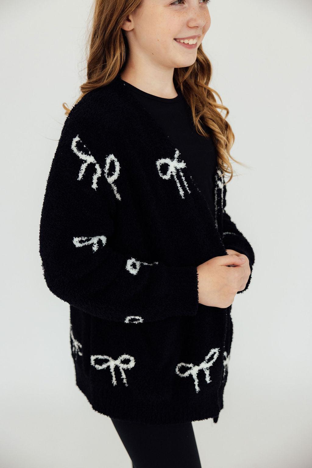 Black fuzzy bow-pattern cardigan with long sleeves and button-front
