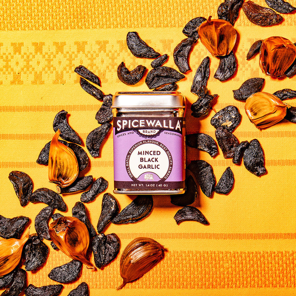 Spicewala minced black garlic seasoning jar with scattered black garlic pieces