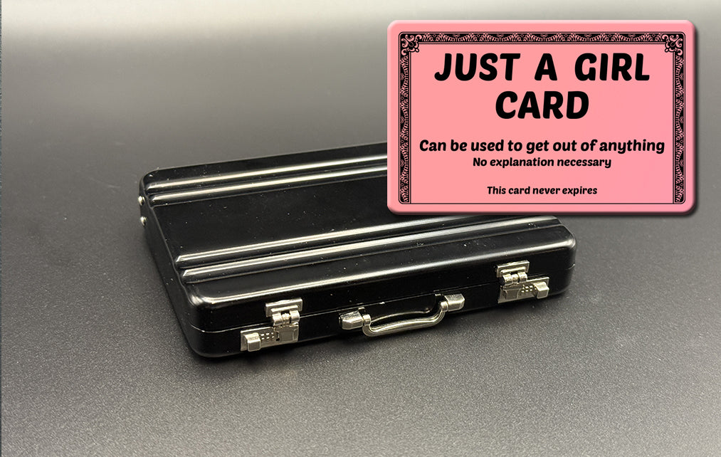 Black mini briefcase with pink 'JUST A GIRL CARD' insert card overlay.