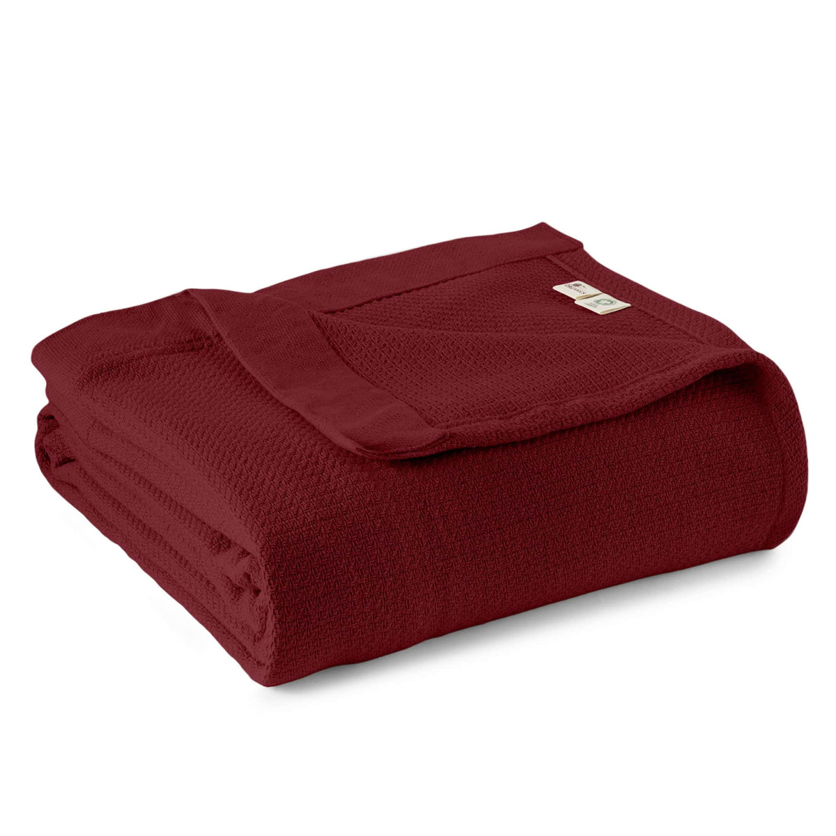 Burgundy woven blanket folded with textured weave and stitched edge.