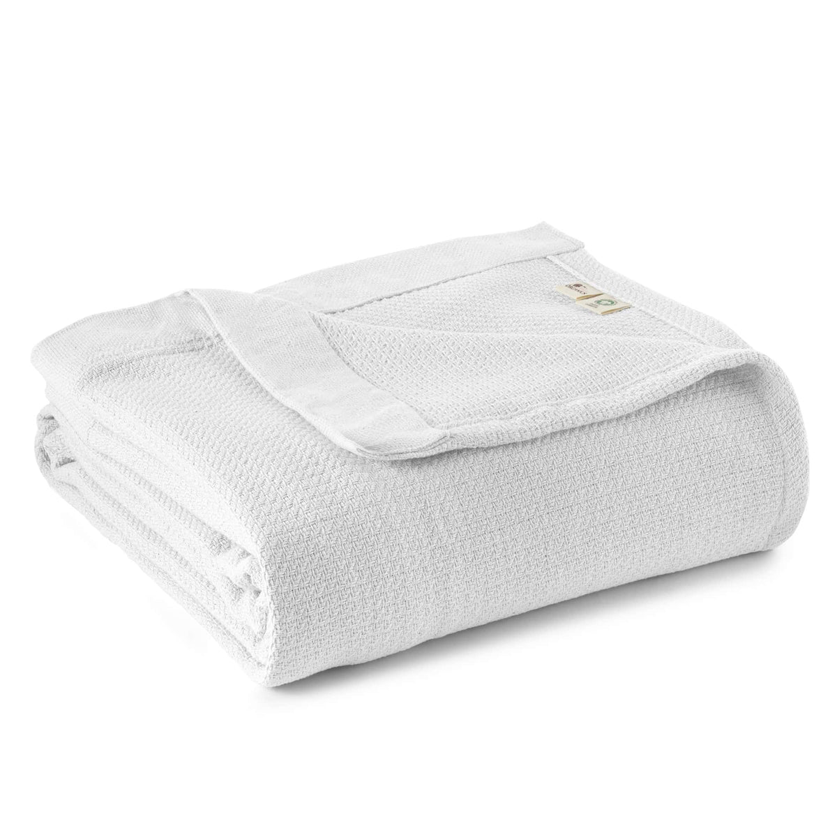 White woven blanket folded with textured weave and stitched edge.