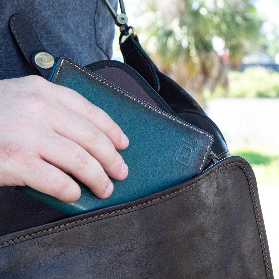 Dark teal blue leather passport wallet with embossed logo and stitched corner detail