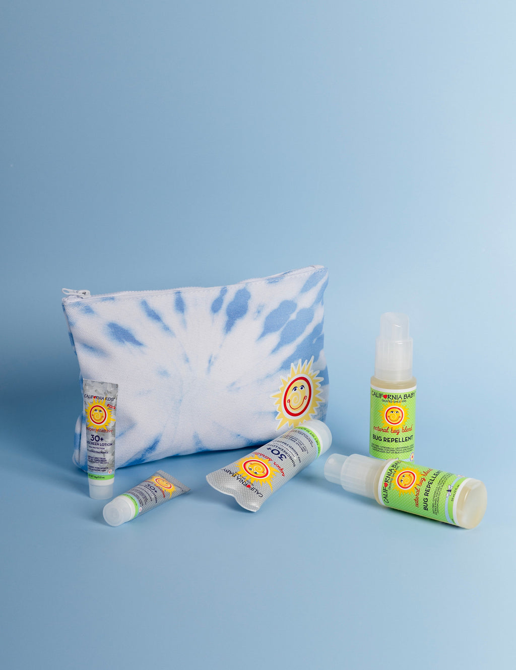 Blue tie-dye zippered travel pouch with sun-face patch on the front