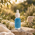 Blue face serum bottle with white dropper cap and calm-clear serum